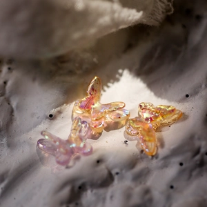 Macro shot of iridescent resin mini butterflies for DIY jewelry and nail art