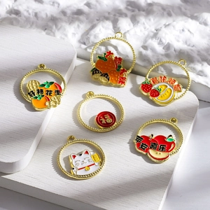 Detailed view of alloy enamel charms featuring festive lucky patterns and cat motifs