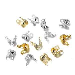 Macro detail of 18K gold and silver plated bead chain end clasps for DIY jewelry making