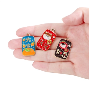Detailed view of three alloy enamel lucky charms with traditional Chinese symbols