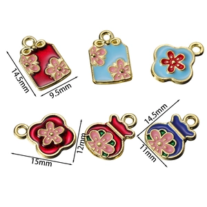Detail of enamel alloy pendants showing precise measurements between 11mm and 15mm