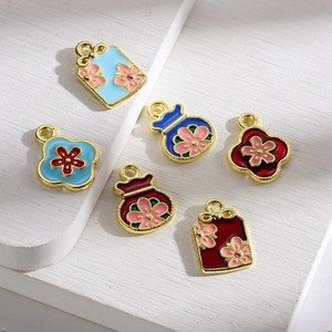 Detailed macro view of 6 enamel flower charms with golden metal plating for DIY jewelry