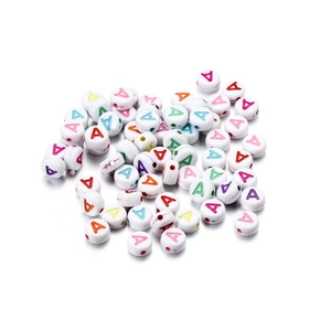 Macro shot of white acrylic round beads with colorful printed letter A for DIY jewelry