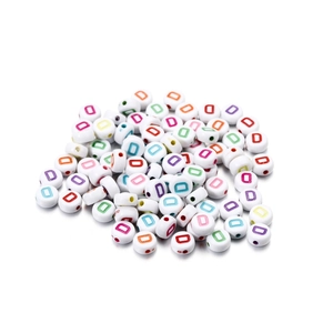 Detailed macro view of white acrylic beads featuring colorful letter D for jewelry making
