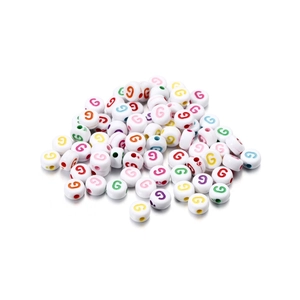 Close-up of white acrylic round beads with colorful letter G print for DIY bracelets