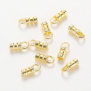 Macro view of 18K gold plated necklace end caps with embossed star patterns
