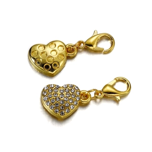 Macro shot of gold heart charms with crystal pavé and lobster claw clasps for jewelry DIY