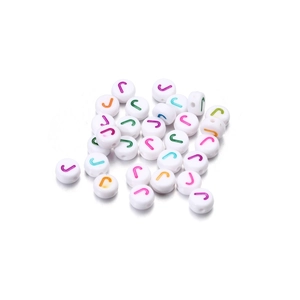 Close-up of white acrylic letter J beads with colorful engraving for DIY jewelry making