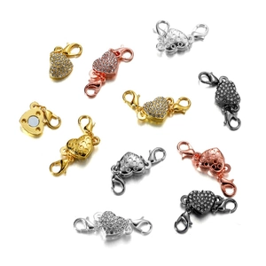 Macro detail of heart magnetic jewelry clasps with rhinestones in four metal finishes