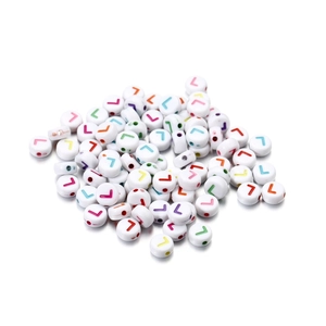 Macro view of white acrylic round beads featuring colorful printed letter L for DIY jewelry