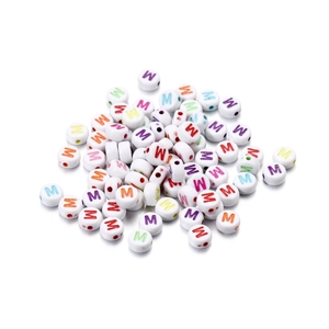 Close-up of white acrylic round flat beads with colorful printed letters for DIY jewelry