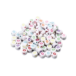 Macro shot of white acrylic round beads with colorful letter O for DIY jewelry making