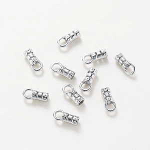 Polished silver jewelry end caps with star engraving and closed loops for necklaces
