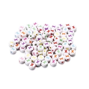 Macro detail of white acrylic letter beads with colorful X print for DIY jewelry making