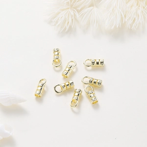 Macro view of 18K gold-plated striped end caps with star engraving for jewelry making