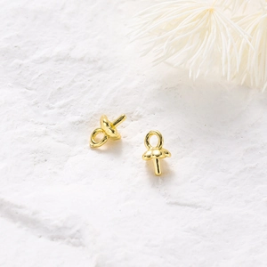 Macro shot of 14K gold plated peg bails jewelry findings with a bright metallic finish
