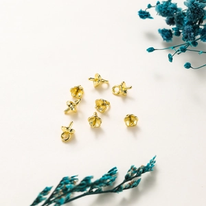 Macro shot of 14K gold pumpkin petal pearl cup bails for DIY jewelry making