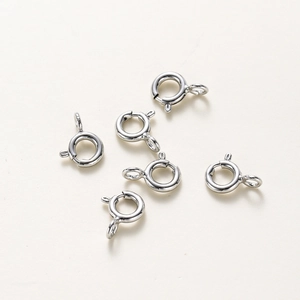 Detail shot of six silver spring ring clasps for jewelry making in high-quality finish