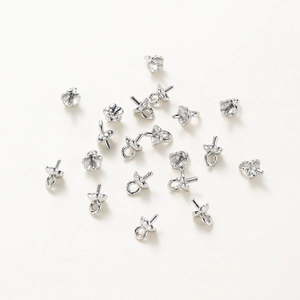 Macro detail of 14K gold-plated petal pearl cup bails with pins for DIY jewelry making
