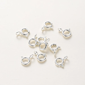 Close-up of bright silver spring ring clasps for DIY jewelry making and necklaces