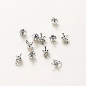 Silver flower-shaped jewelry clasp for pearls, macro view of the five-petal tray detail