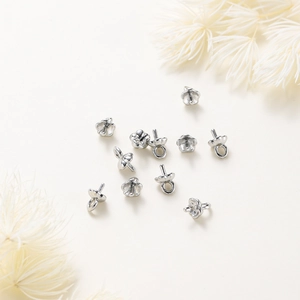 Detailed view of silver polished flower shaped pearl cup and peg jewelry connectors