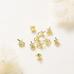 Macro shot of 14K gold floral pearl cup pendants for DIY jewelry making accessories