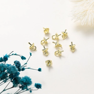 Macro shot of 14K gold-plated flower pearl peg bails for DIY jewelry making