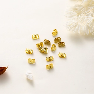 Macro detail of 18K gold plated copper butterfly earring backs for jewelry making