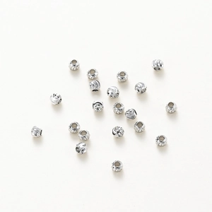 Macro shot of 18K gold plated copper beads with spiral textured grooves for jewelry DIY