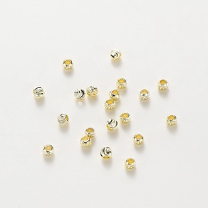 Macro detail of gold plated copper spacer beads with spiral texture for DIY jewelry