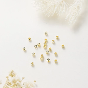 Detail of 18K gold plated faceted beads for DIY jewelry making with spiral texture