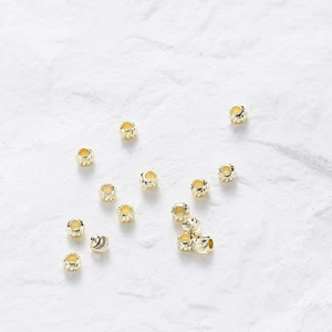 Macro shot of 18K gold plated copper beads with spiral texture for DIY jewelry making