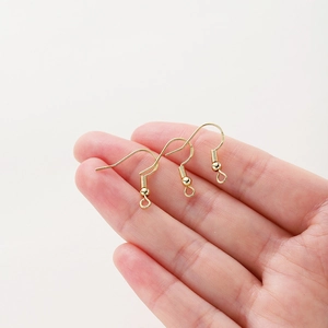 Detailed view of DIY 14K gold plated earring hooks with spring coils and loop beads