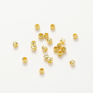 Macro view of 18K gold-plated copper spacer beads with spiral textured patterns for DIY jewelry