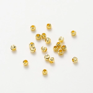 Macro shot of 18K gold plated copper beads with spiral textures for DIY jewelry making