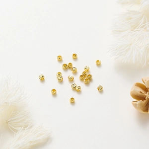 Macro shot of 18K gold plated copper beads with spiral engraved texture for DIY jewelry