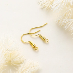 Detail of S925 stamped gold-plated earring hooks with small bead and open loop