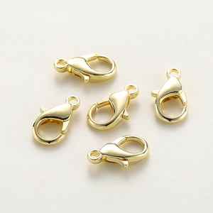 Five gold plated copper lobster clasps for jewelry making displayed on a light background