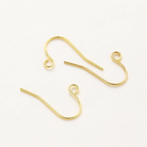 Close-up of polished gold-plated earring hooks with small loops for DIY jewelry making
