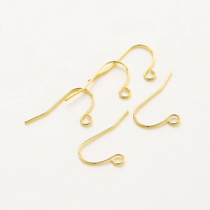 Macro view of four polished gold French ear hooks for DIY earring jewelry making