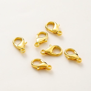 Macro shot of 14k gold plated lobster clasps for DIY jewelry making and bracelet repairs