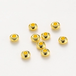 Macro shot of 18K gold plated flat spacer beads for DIY jewelry making and bracelets