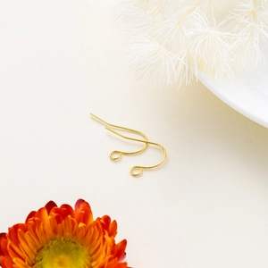 Macro detail of classic gold-plated fish hook earrings with loop for DIY jewelry making