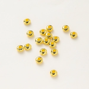 Macro shot of 18K gold plated polished wheel spacers with holes for DIY jewelry