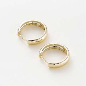 Detailed view of 14K gold plated chunky hoop earrings with high-polished glossy surface