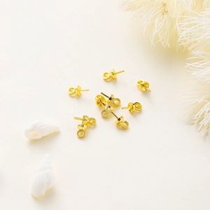 Detailed view of 14K gold-plated earring posts with pearl trays and hanging rings for DIY