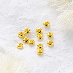 Macro shot of 18K gold plated wheel spacer beads with polished mirror finish for DIY jewelry