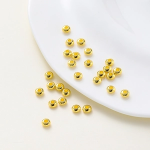 Macro shot of 18K gold plated wheel-shaped spacer beads for DIY jewelry making