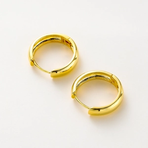 Detailed close-up of 14K gold plated hoop earrings with a polished mirror finish
